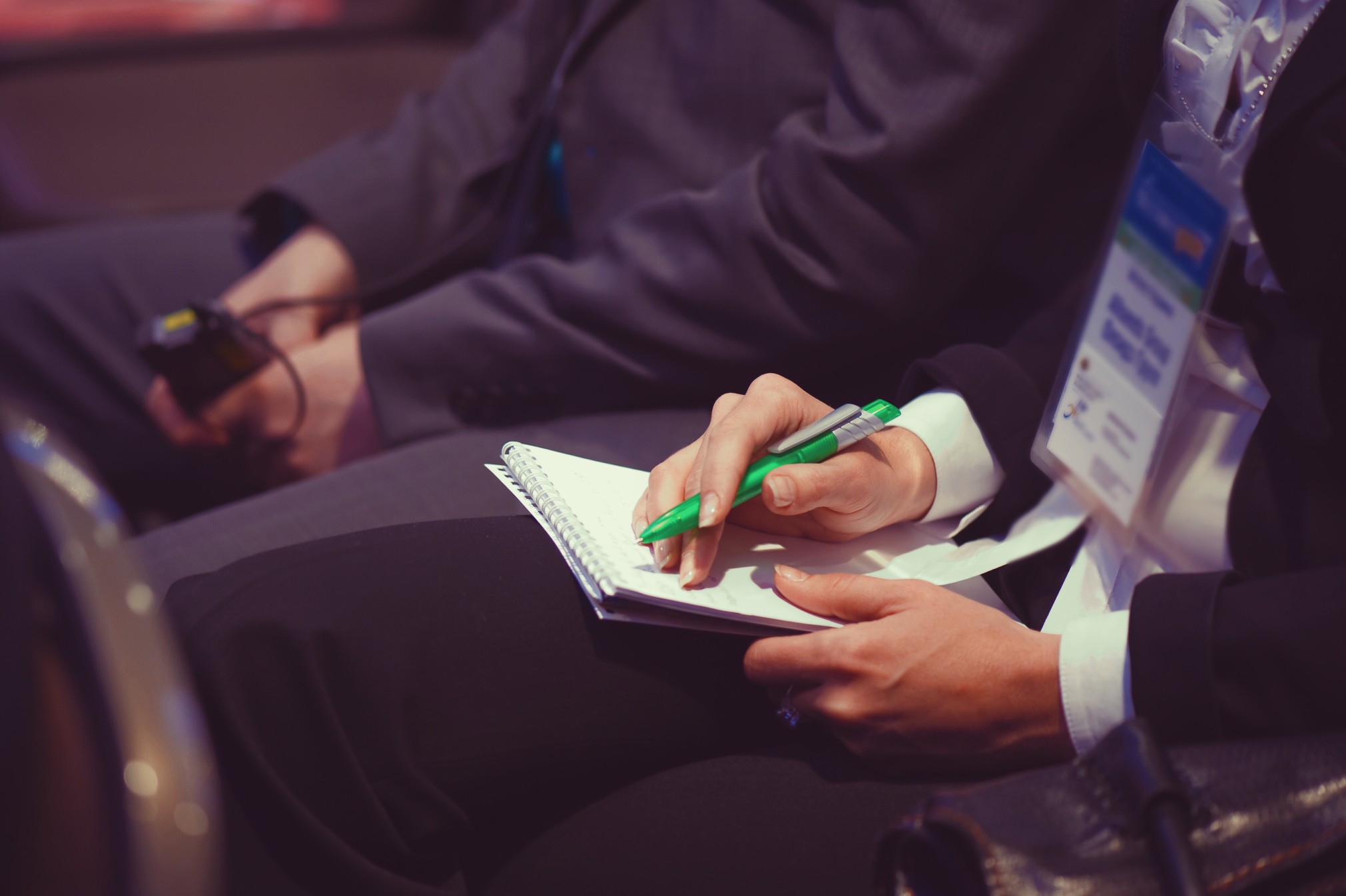 event conference attendee writing